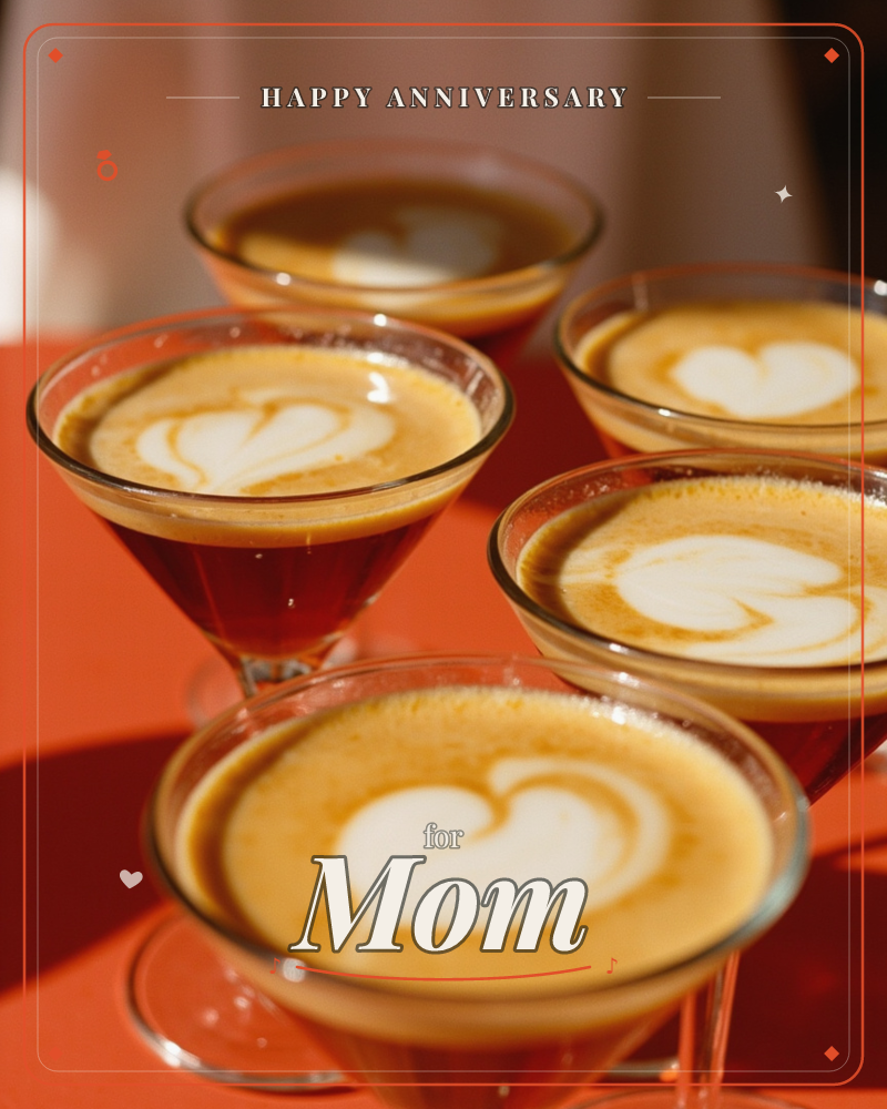 A cluster of glass coupes filled with frothy coffee cocktails, each topped with a heart traced in cream, sits on a bright orange tablecloth in warm…, a anniversary e-card design