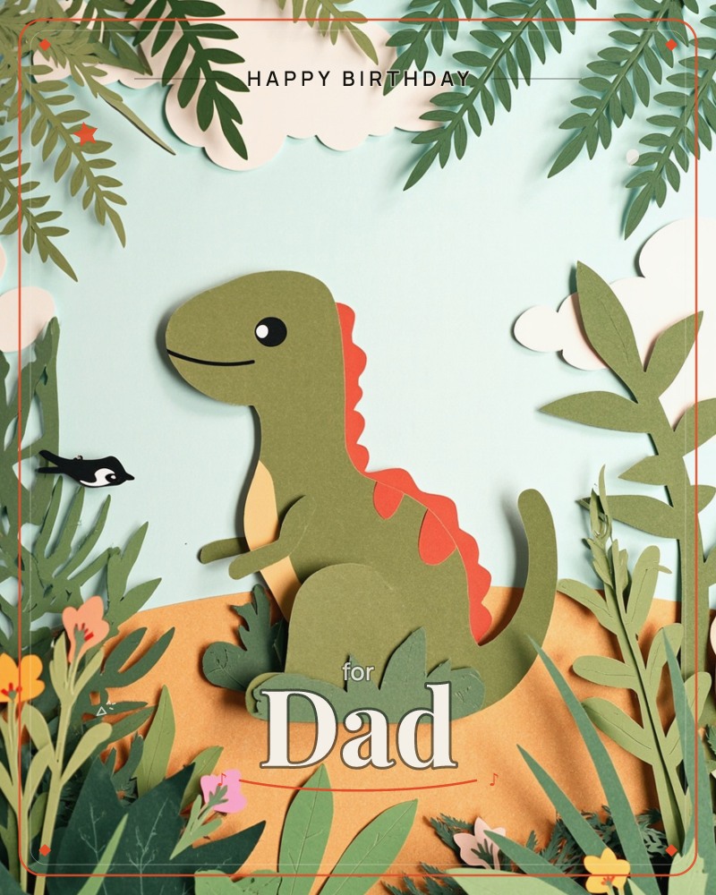 A cheerful green paper-cut dinosaur sits smiling on a sandy mound, its curved tail and stumpy arms rendered in layered card, a birthday e-card design