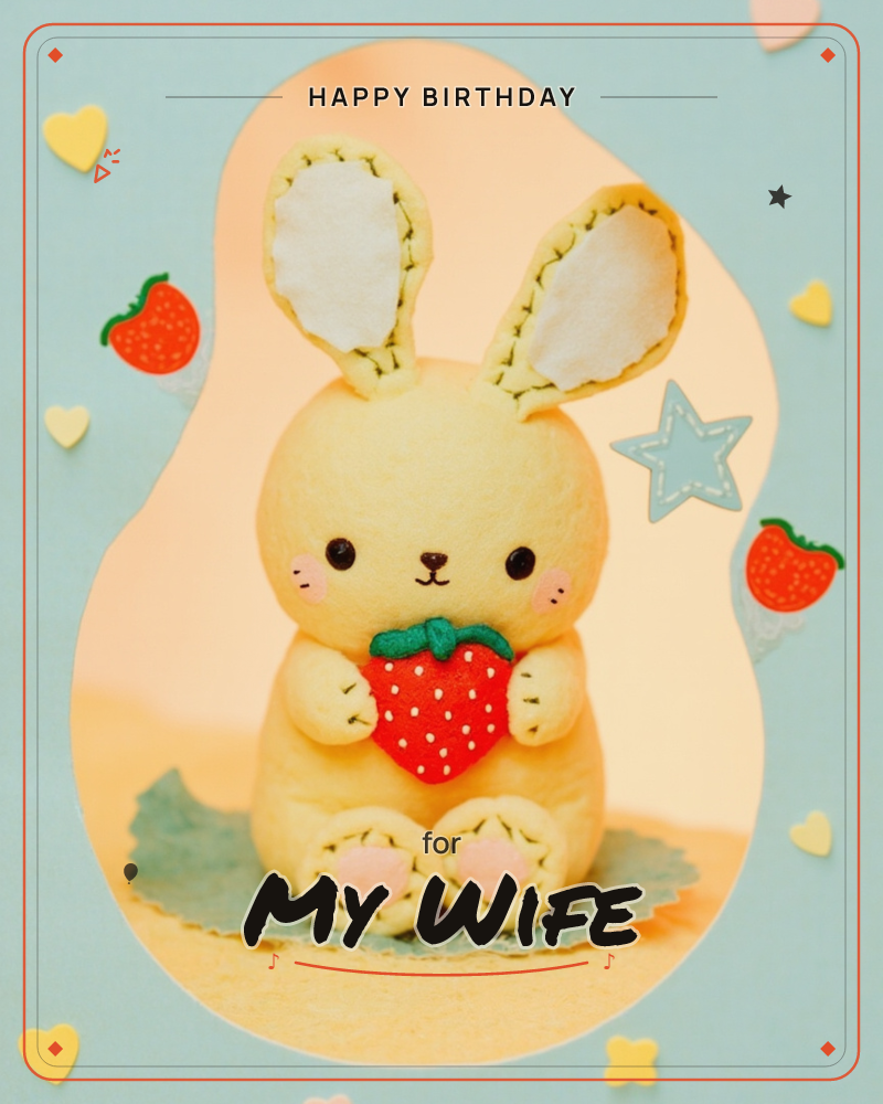 A handmade felt bunny with tall stitched ears sits on a felt leaf, blushing pink cheeks and hugging a plush strawberry to its chest, a birthday e-card design