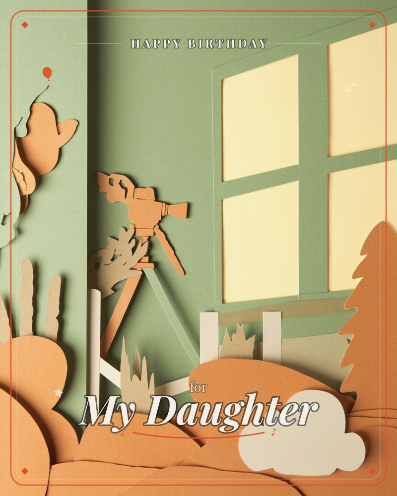 A paper-cut diorama shows a vintage camera on a tripod set up before a paned window glowing with warm light, framed by layered cutout hills, a tree, a…, a birthday e-card design