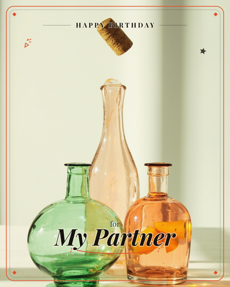 Three glass bottles catch soft afternoon light on a pale tabletop: a round green vessel, a slender amber carafe, and a smaller orange bottle holding…, a birthday e-card design