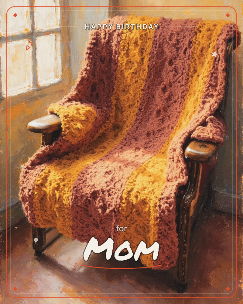 A worn wooden armchair sits by a paned window, draped in a thick crocheted afghan striped in mustard, burnt orange, and rust, a birthday e-card design