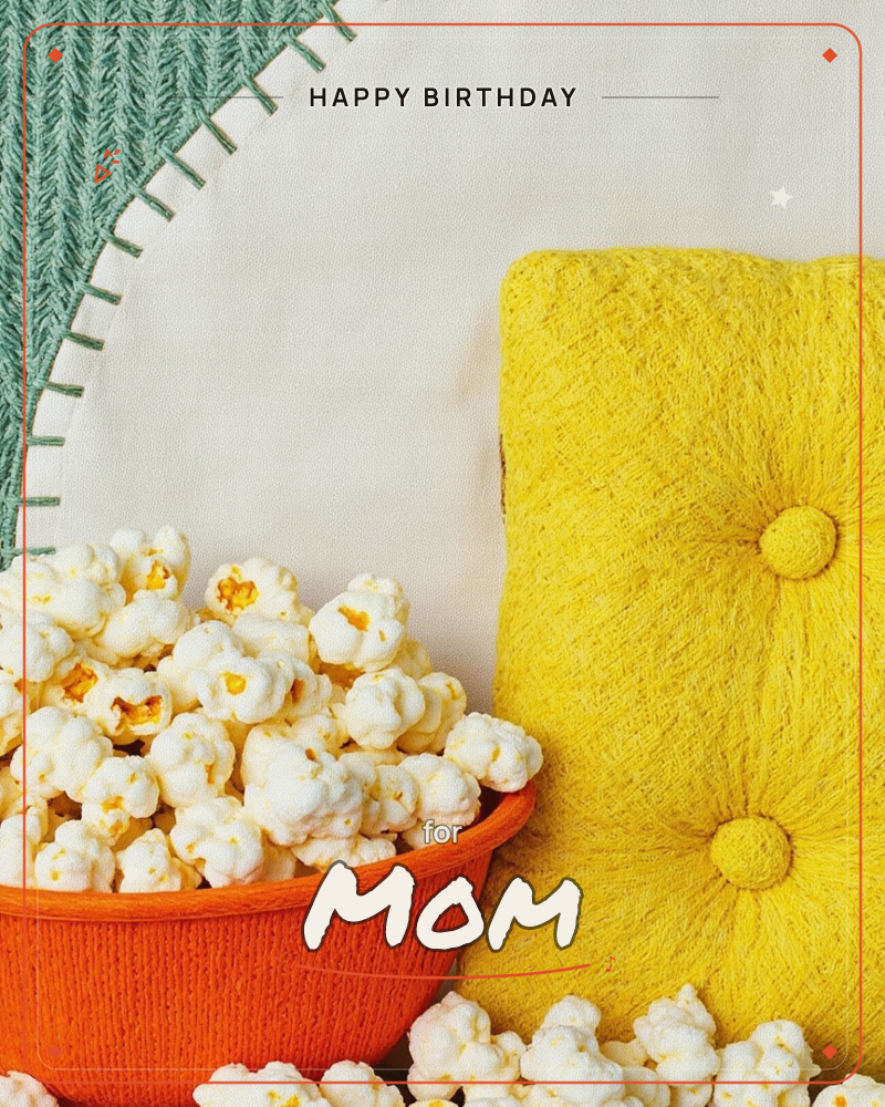 A cosy, felted-textile still life shows an orange knitted bowl overflowing with fuzzy popcorn, set beside a tufted yellow cushion and a sage-green…, a birthday e-card design
