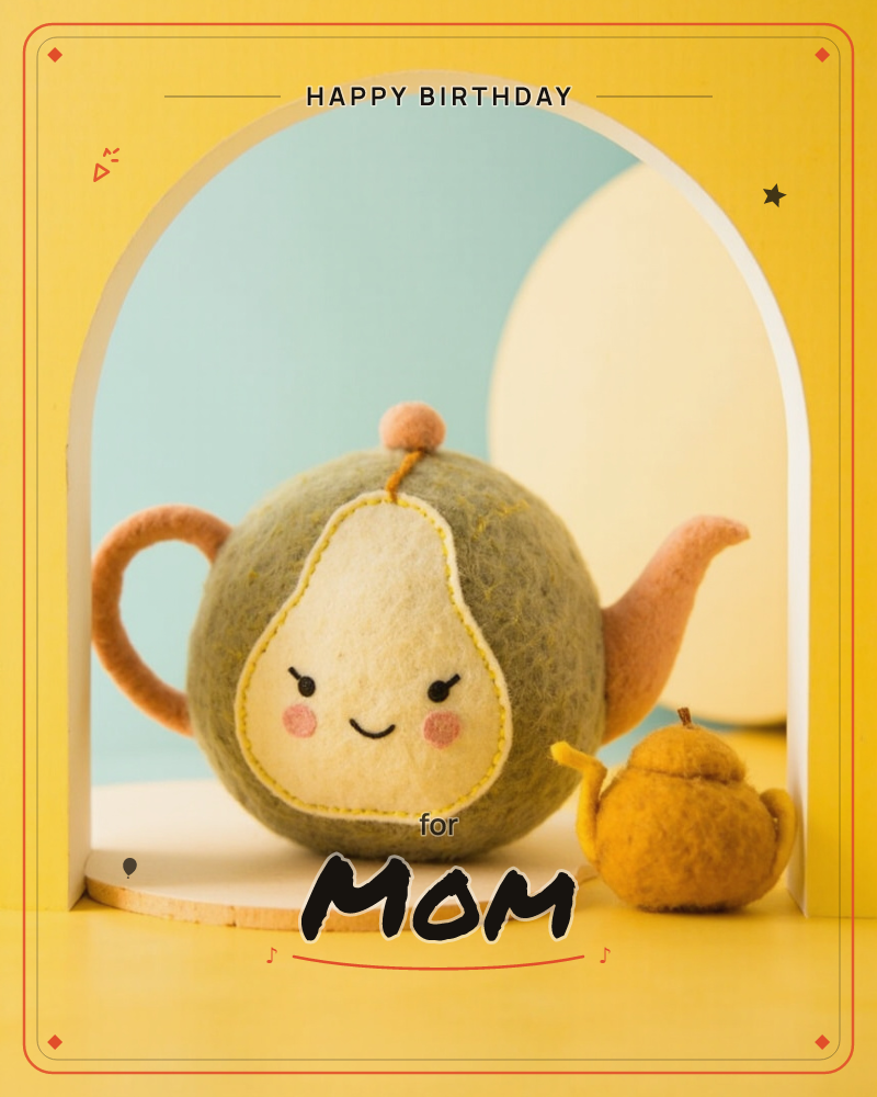 A felted wool teapot shaped like a smiling pear sits inside a white arched nook, its rosy cheeks and stitched face giving it a soft, handmade charm, a birthday e-card design