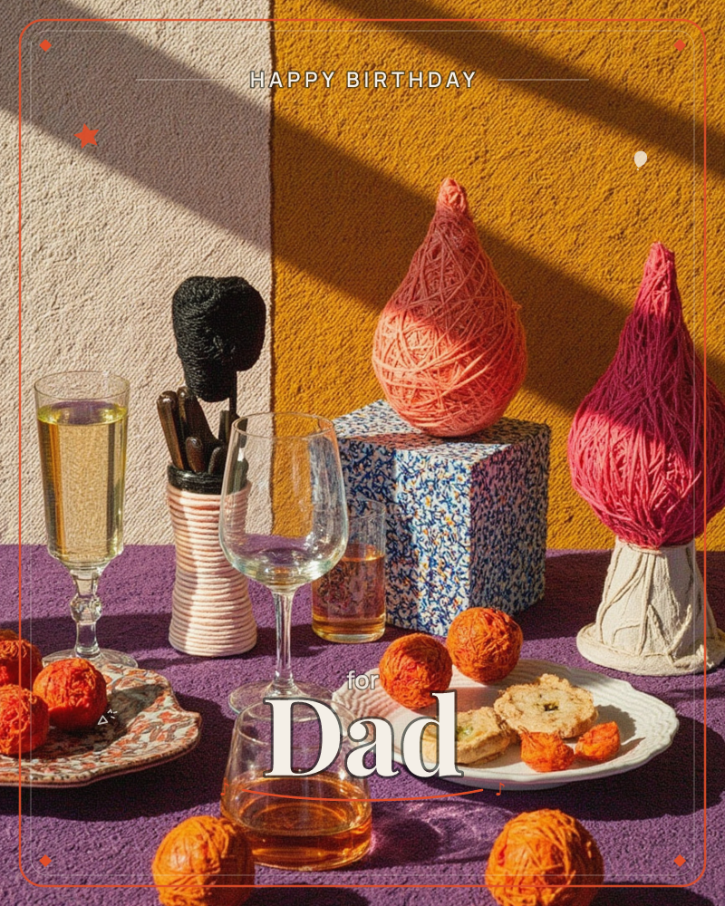 A sunlit tabletop scene styled like a festive still life, with champagne and whisky glasses, a patterned box, and pastries arranged on plates draped in…, a birthday e-card design