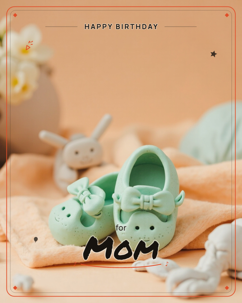 A pair of tiny mint-green baby shoes with bow trims and smiling faces sits on a folded peach towel, with a soft grey bunny toy blurred in the…, a birthday e-card design