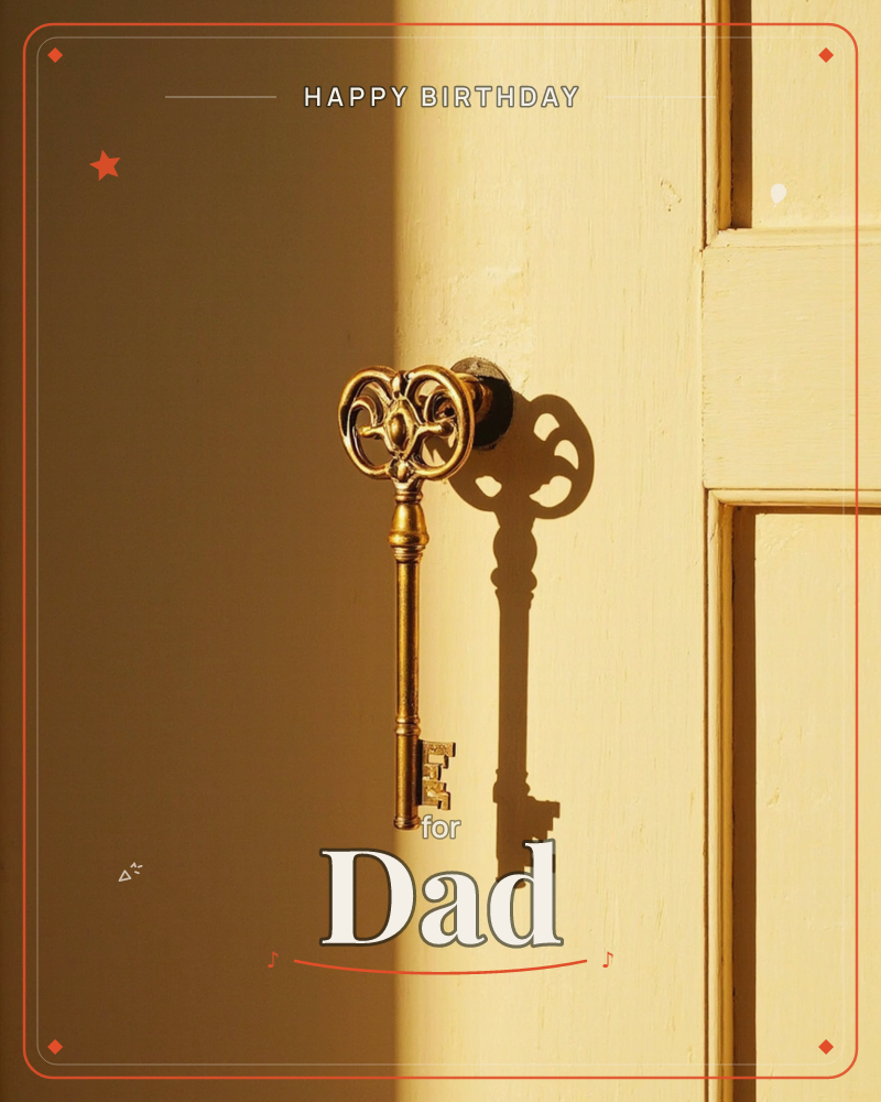 An ornate brass key hangs from a small knob set into a pale yellow door frame, caught in warm slanting light, a birthday e-card design