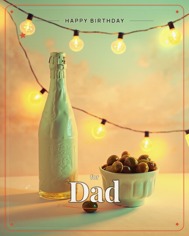 A pale embossed bottle stands beside a fluted bowl heaped with green olives, one olive rolled loose onto the table, a birthday e-card design