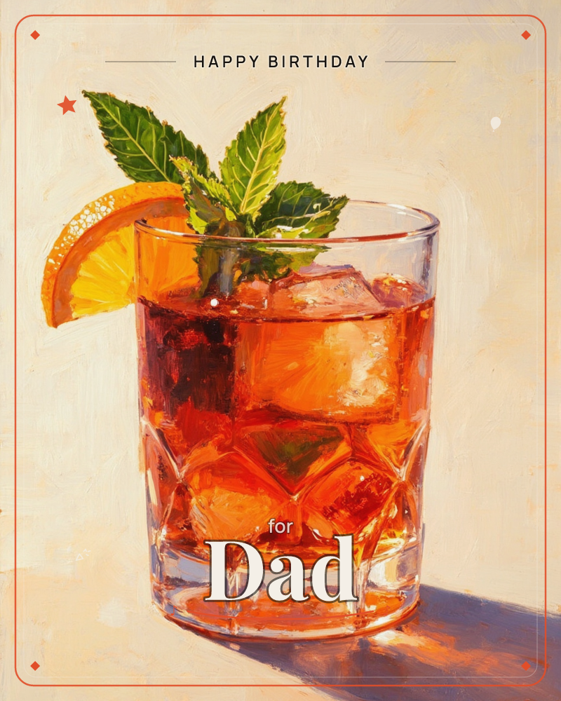 A cut-glass tumbler holds a deep amber-red cocktail over a fat block of ice, garnished with a curled orange slice and a sprig of fresh mint, a birthday e-card design