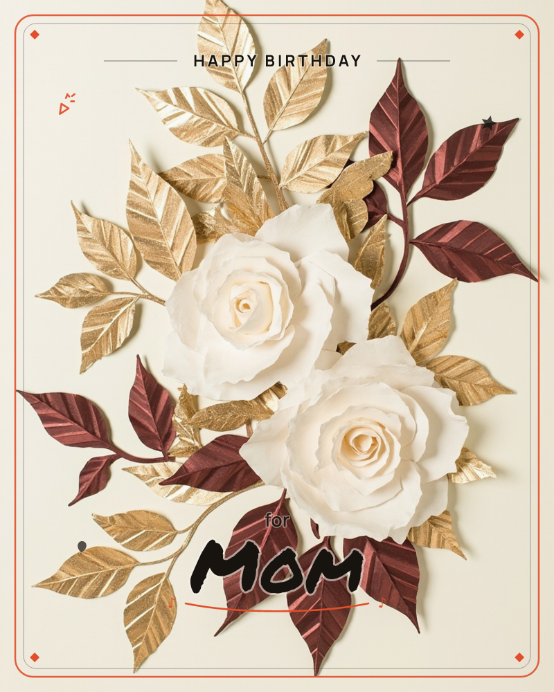 Two ivory-white roses sit at the centre of a paper-craft spray of gilded gold leaves and deep burgundy foliage, arranged against a soft cream background, a birthday e-card design