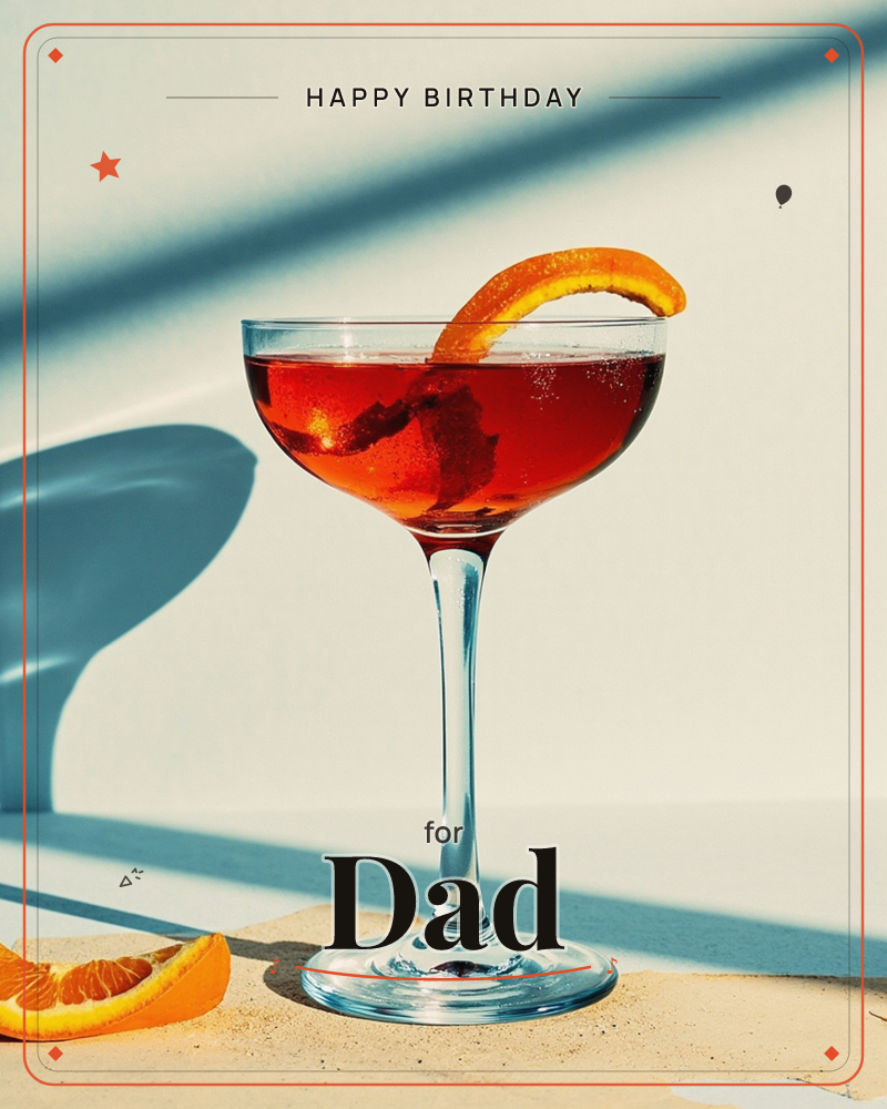 A coupe glass of deep red-orange cocktail sits on a sandy ledge against a plain wall, garnished with a curled orange twist, hard sunlight casting a…, a birthday e-card design