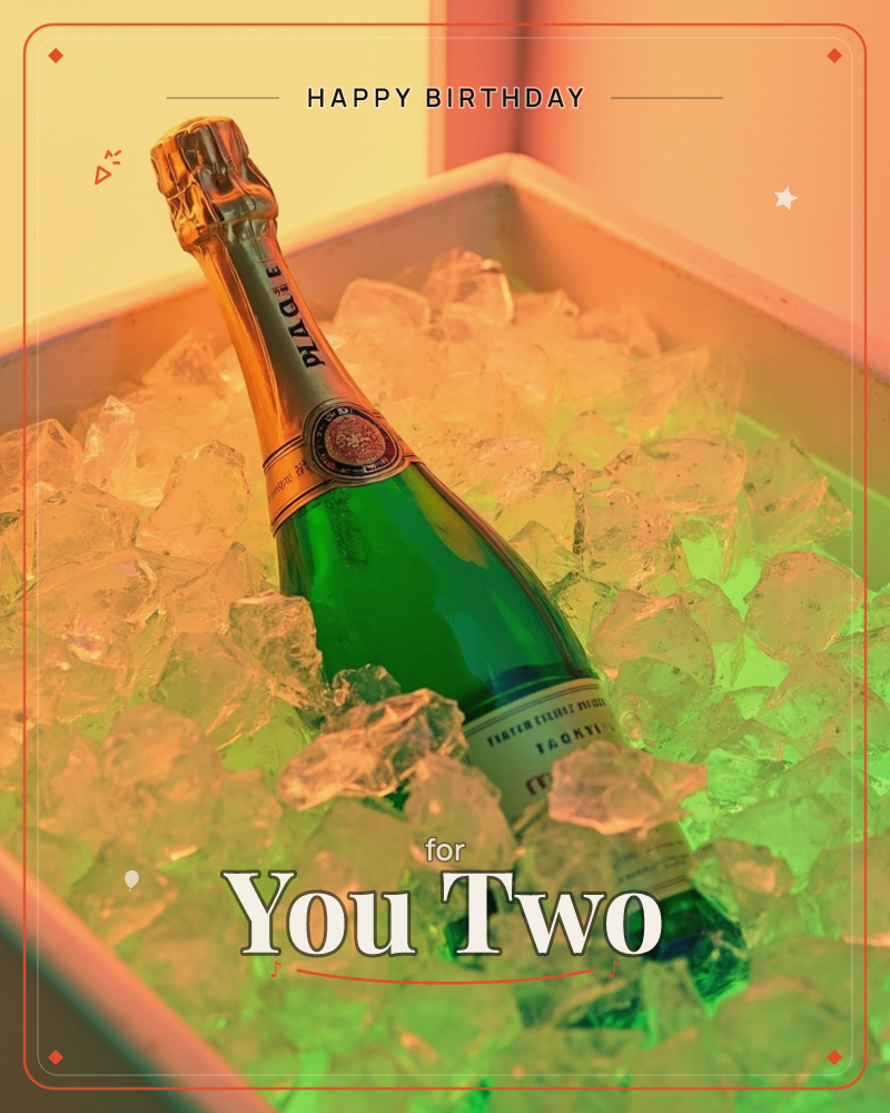 A green champagne bottle rests nestled in a square ice bucket, the ice glowing under warm amber and green light, a birthday e-card design