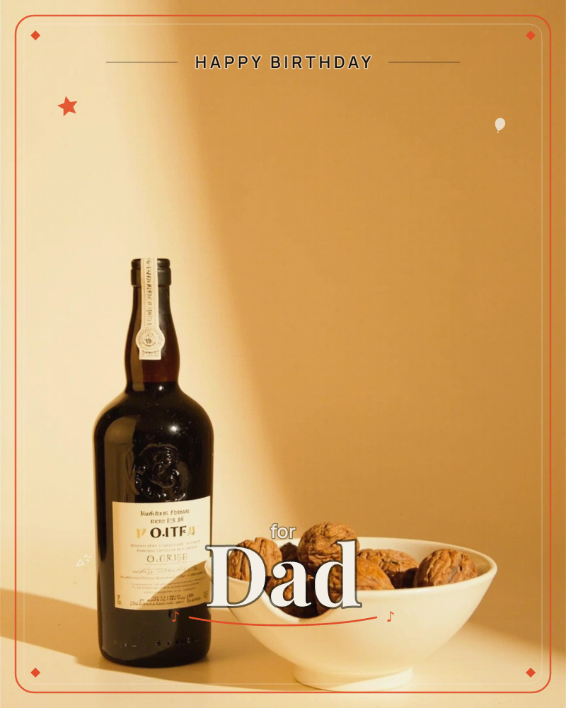 A dark bottle of port and a white ceramic bowl heaped with walnuts sit side by side against a warm ochre wall, a diagonal shaft of light cutting across…, a birthday e-card design