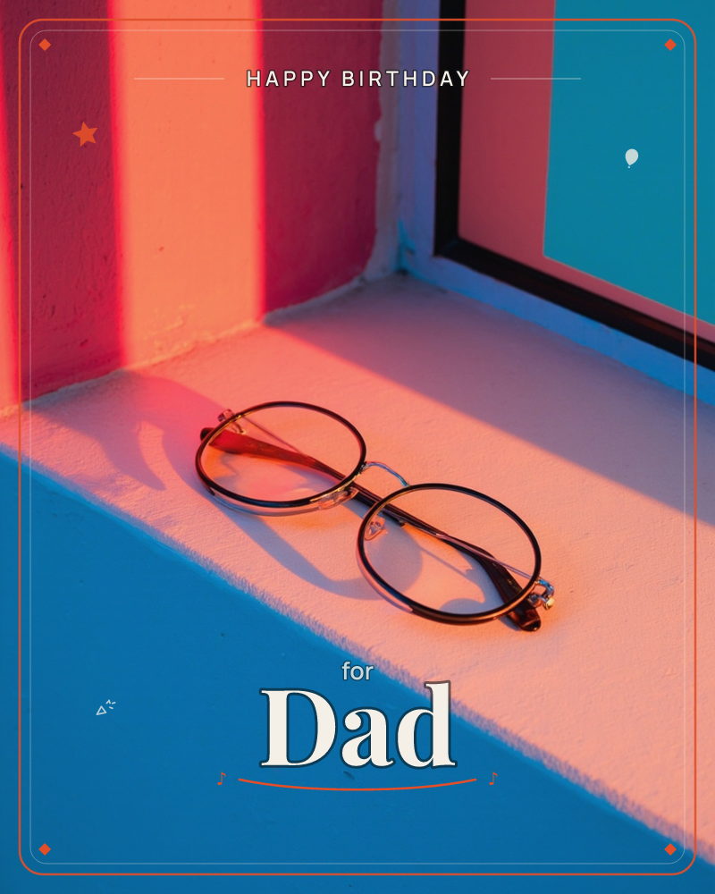 A pair of round wire-framed glasses rests folded on a pale windowsill, caught in a wash of coral-pink light streaming through a window frame, a birthday e-card design