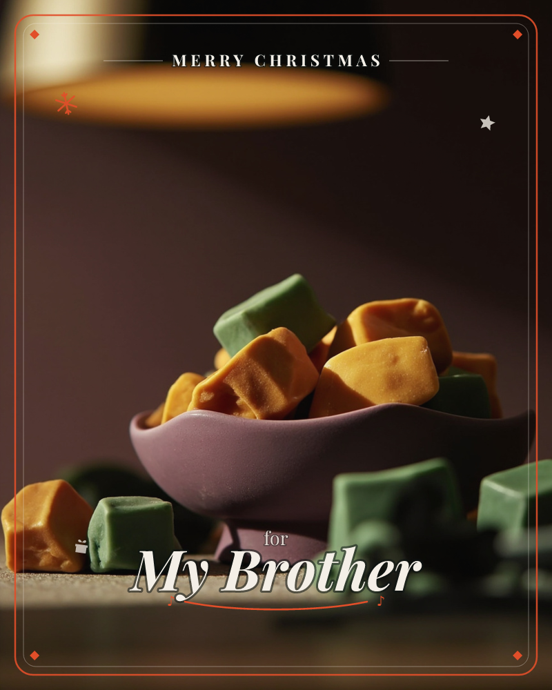 A mauve ceramic bowl overflows with chunky orange and sage-green candy cubes, lit by a warm hanging lamp above, a christmas e-card design