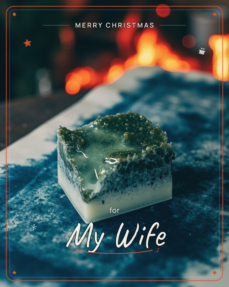 A square of glossy jade-green dessert sits on an indigo tie-dyed cloth, its rippled top catching the light like frozen water over cream-white layers below, a christmas e-card design