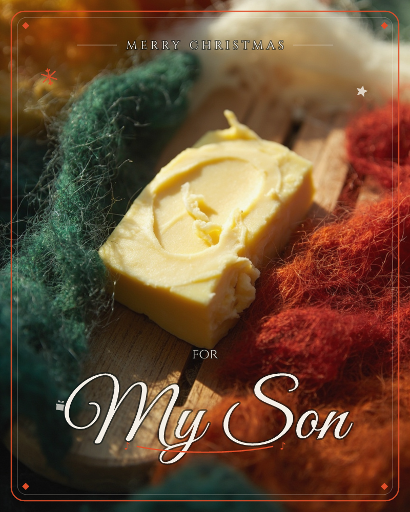 A block of pale yellow butter sits on a wooden board, its top swirled with a knife, surrounded by tufts of raw dyed wool in teal, rust and cream, a christmas e-card design