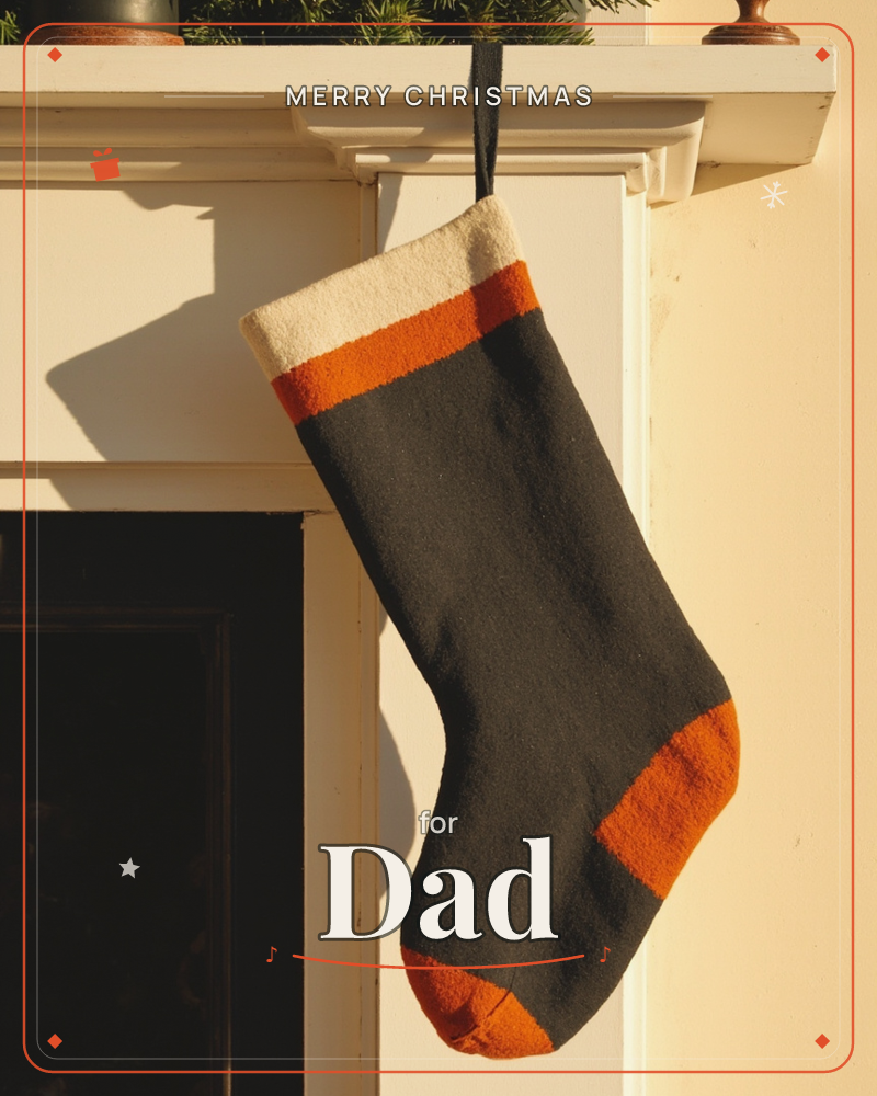 A single wool stocking hangs from a black loop on a white mantelpiece, its dark charcoal body trimmed with burnt orange at the cuff, heel and toe above…, a christmas e-card design