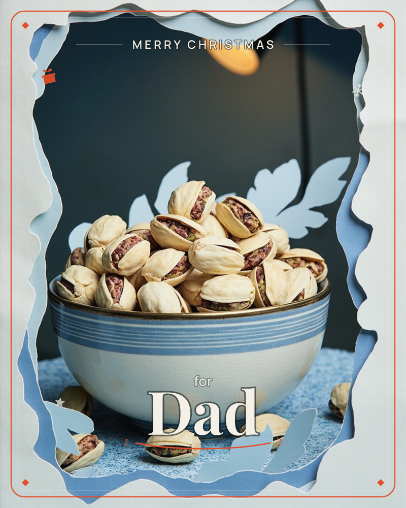 A blue-and-white striped bowl sits piled high with pistachios, their shells cracked open to show the nuts inside, a few scattered loose on the speckled…, a christmas e-card design