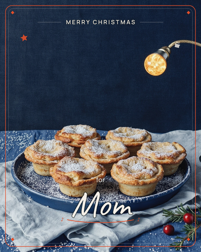 A dark navy backdrop sets off a plate of golden mince pies dusted with icing sugar, arranged on a rustic blue ceramic dish, a christmas e-card design