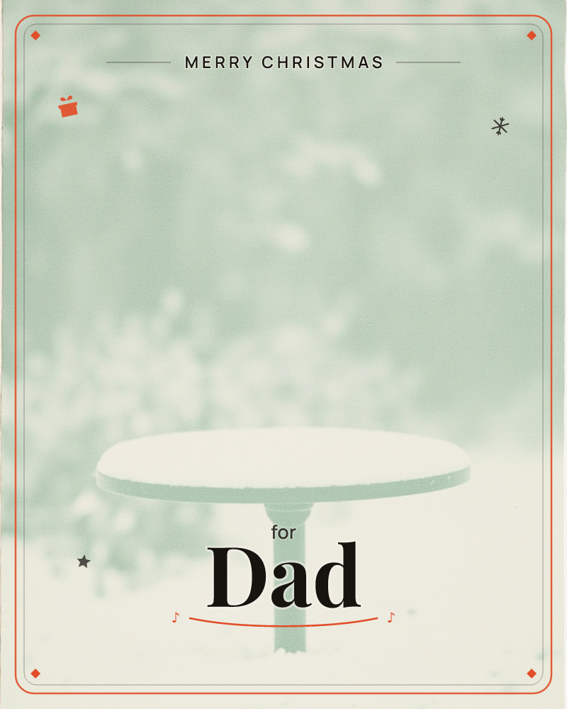 A round garden table sits blanketed in a thick layer of fresh snow, its pedestal base rising from a snow-covered ground, a christmas e-card design