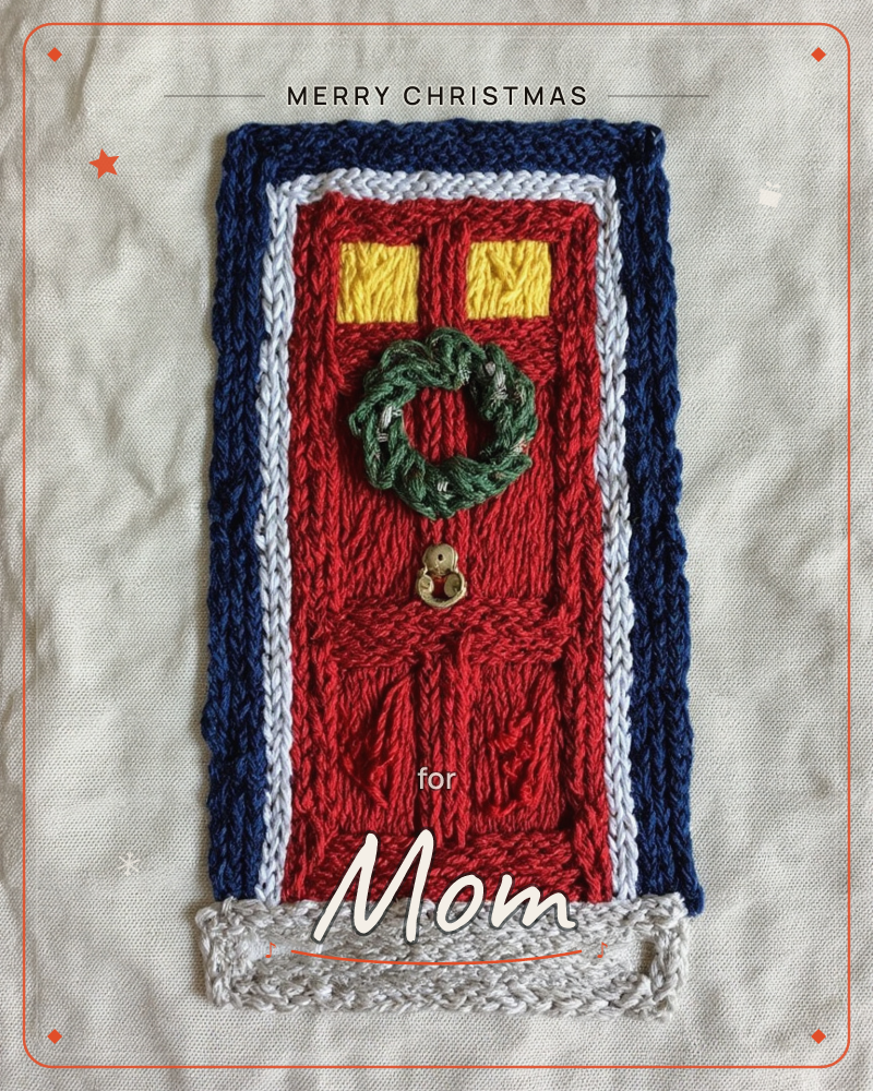 An embroidered red front door sits stitched onto pale linen, framed in navy with a white doorstep and trim, a christmas e-card design