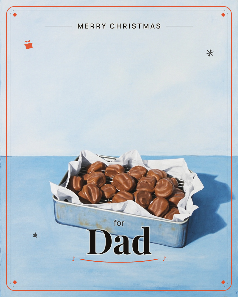 A worn tin box sits open on a pale blue table, lined with crumpled white tissue paper and filled with rows of glossy chocolate-covered sweets, a christmas e-card design