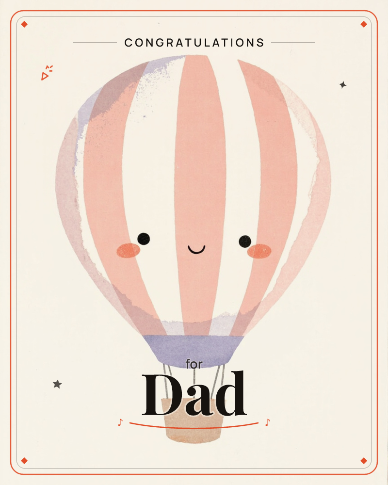 A single hot air balloon floats against a plain cream background, its striped panels of coral, lilac and cream giving way to a smiling face with rosy…, a congratulations e-card design