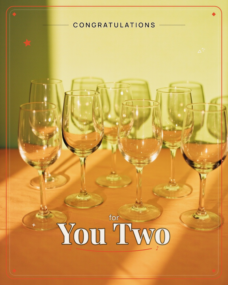 A cluster of empty wine glasses stands on an orange tablecloth, their stems catching diagonal bars of sunlight against a chartreuse wall, a congratulations e-card design