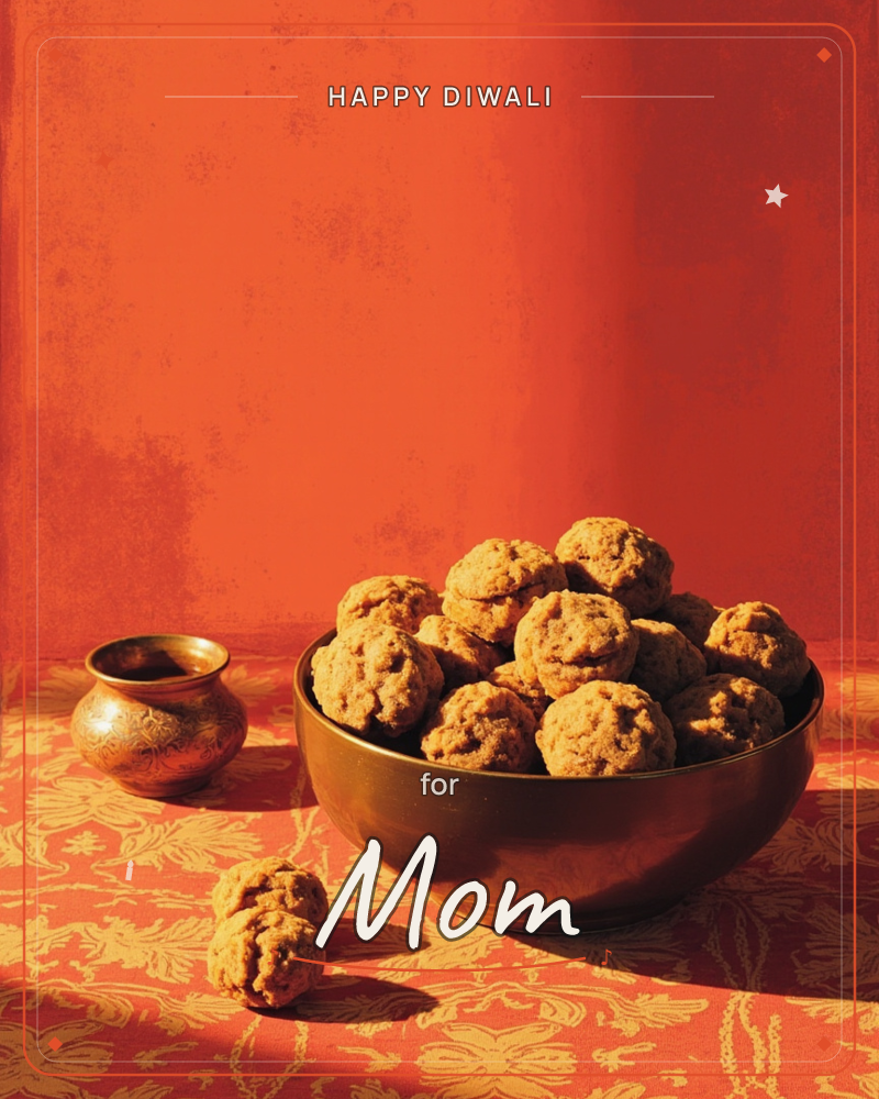 A brass bowl heaped with round, textured sweets sits on a richly patterned orange and gold cloth, with two extra pieces resting beside it and a small…, a diwali e-card design