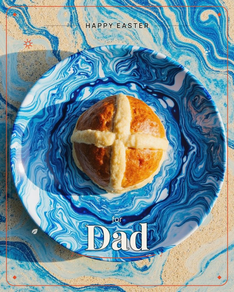 A single glazed hot cross bun sits centred on a swirling blue-and-white marbled plate, its pale pastry cross catching the sunlight, a easter e-card design