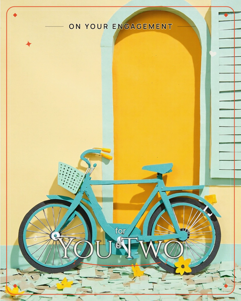 A paper-craft turquoise bicycle with a basket leans against a sunny yellow wall beside an arched mustard doorway and a pale green shutter, a engagement e-card design