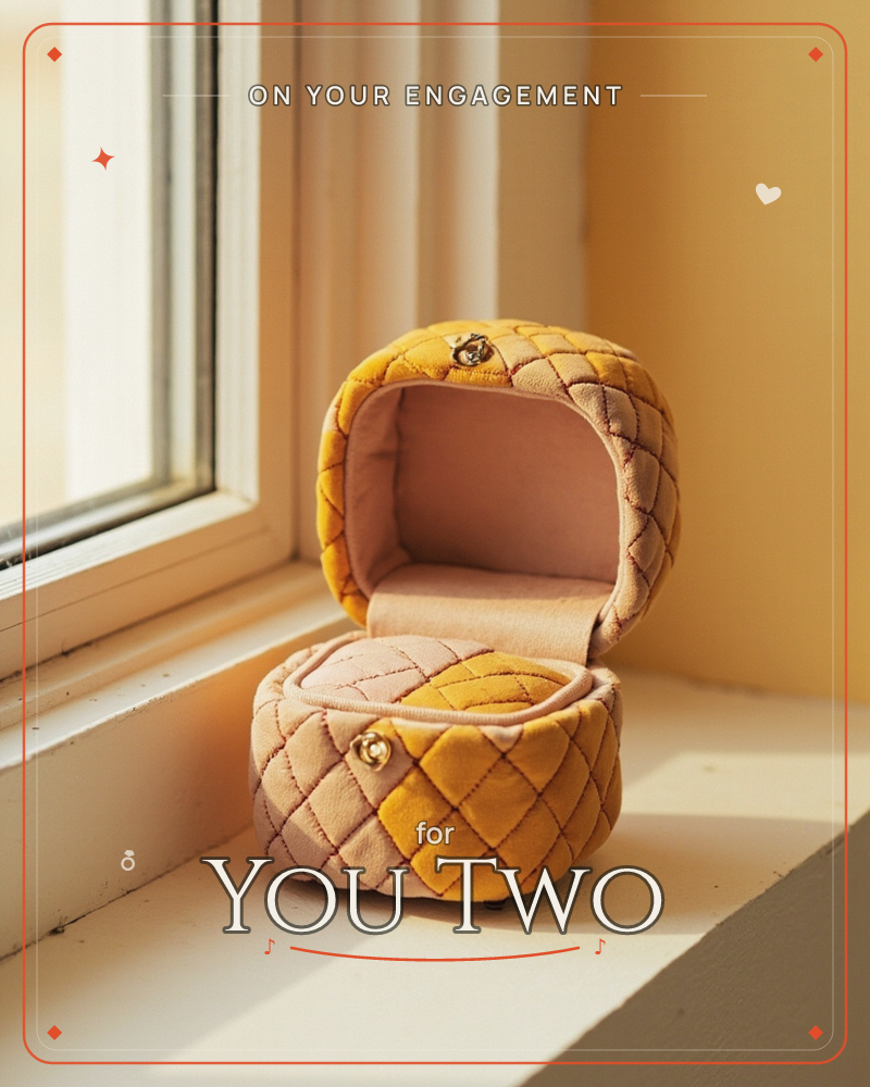A quilted velvet ring box, stitched in mustard and blush diamonds with a tiny gold clasp, sits open on a sunlit windowsill, a engagement e-card design