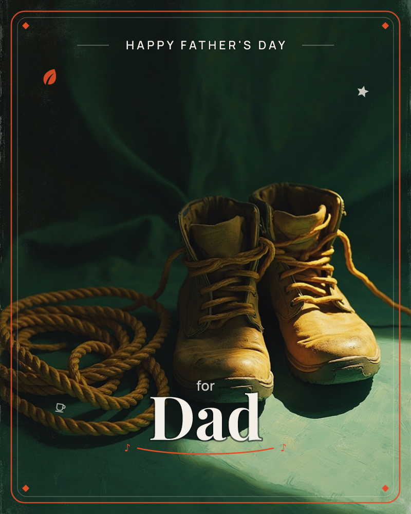 A worn pair of tan work boots stands beside a coiled length of rope, both lit by a single warm shaft of light against a deep green draped backdrop, a fathersday e-card design