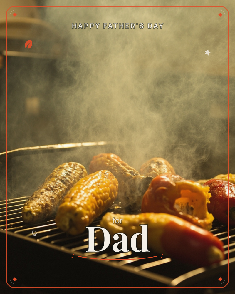 A close-up of corn cobs and glossy peppers charring on a metal grill grate, smoke curling upward and catching warm golden light, a fathersday e-card design