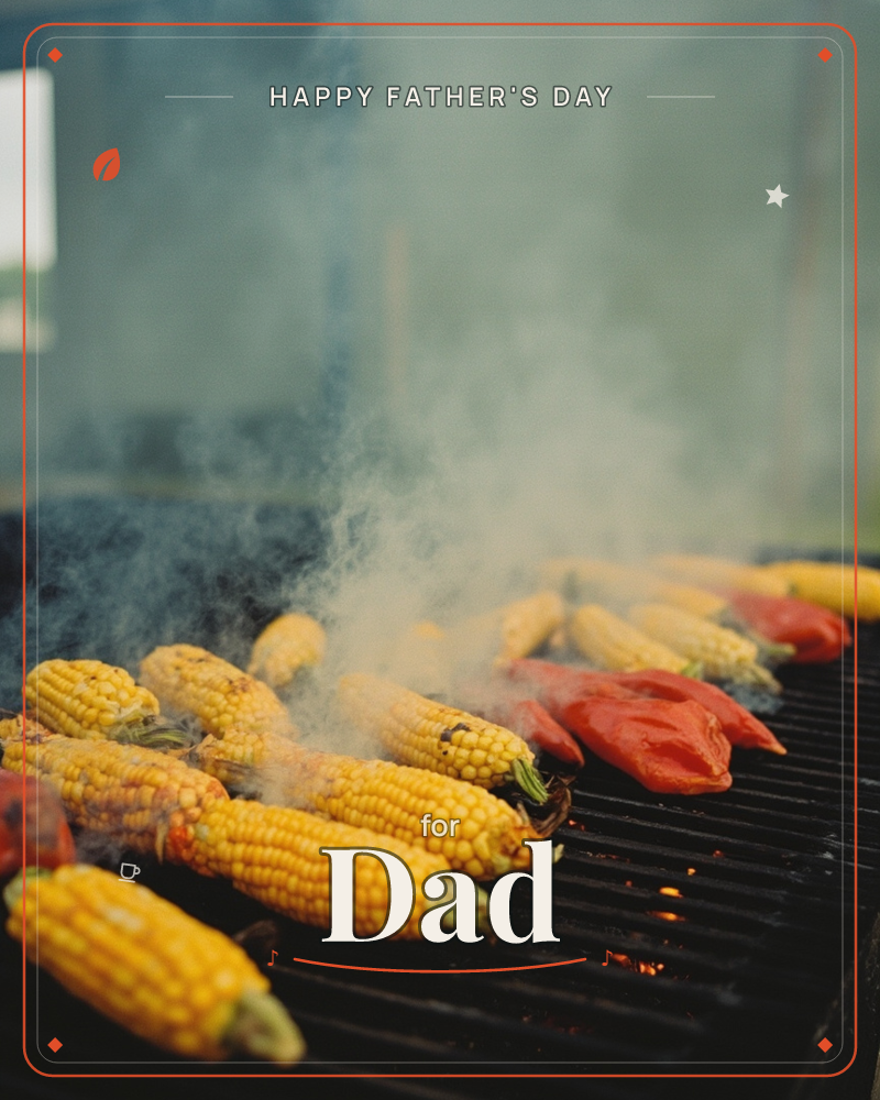 A photographic close-up shows ears of corn and red pepper halves lined up on a smoking charcoal grill, embers glowing beneath the grate, a fathersday e-card design