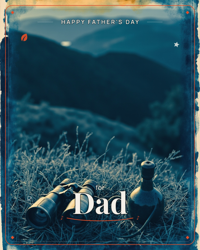 A pair of binoculars and an old leather flask rest in dry grass on a hillside, with layered mountain ridges fading into blue haze behind them, a fathersday e-card design