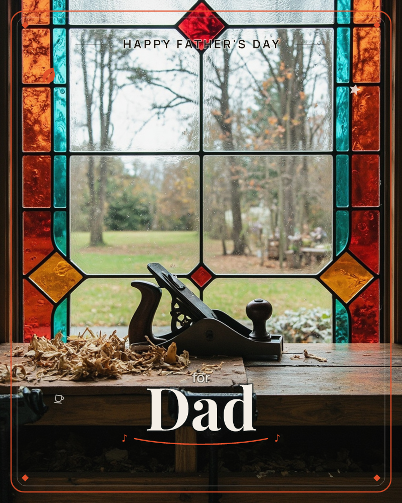 A wooden hand plane rests on a worn workbench beside curls of fresh shavings, framed by a stained-glass window in amber, teal and red panes, a fathersday e-card design