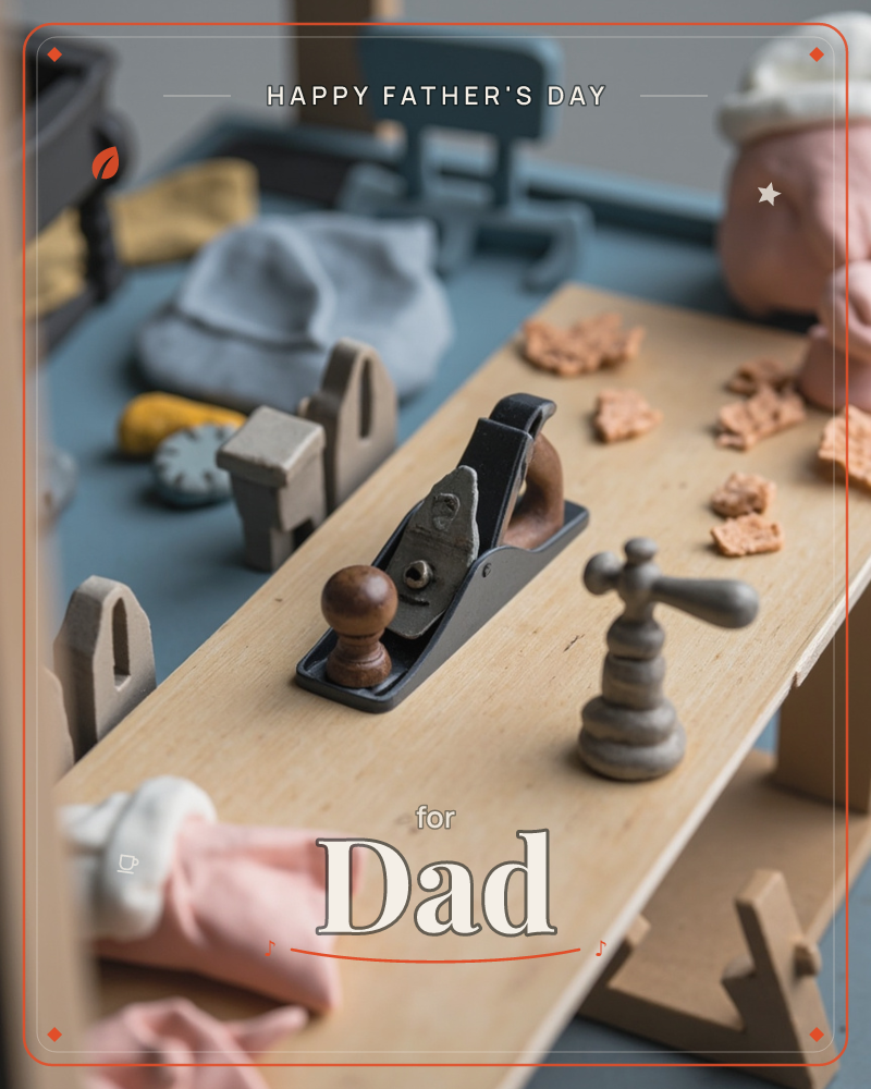 A miniature carpenter's workbench scene, with a wooden hand plane and shavings scattered across the bench top, small clay-toned wood curls, folded…, a fathersday e-card design