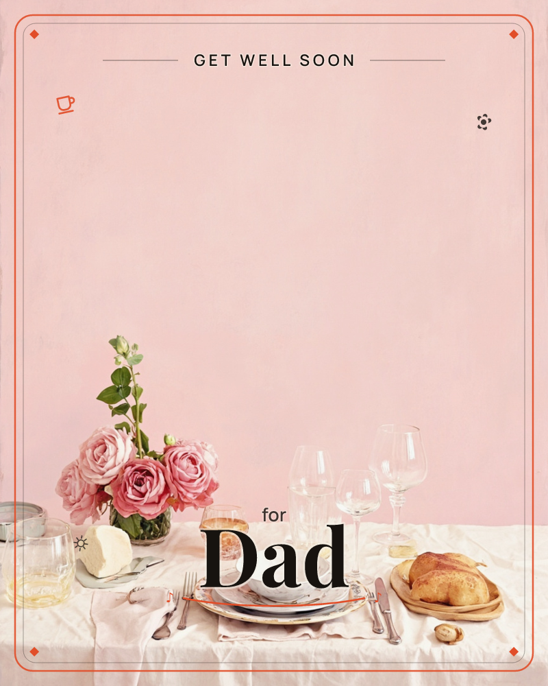 A softly lit table is set against a plain blush-pink wall, with a small glass vase of pink roses beside a place setting of patterned china, wine…, a getwell e-card design