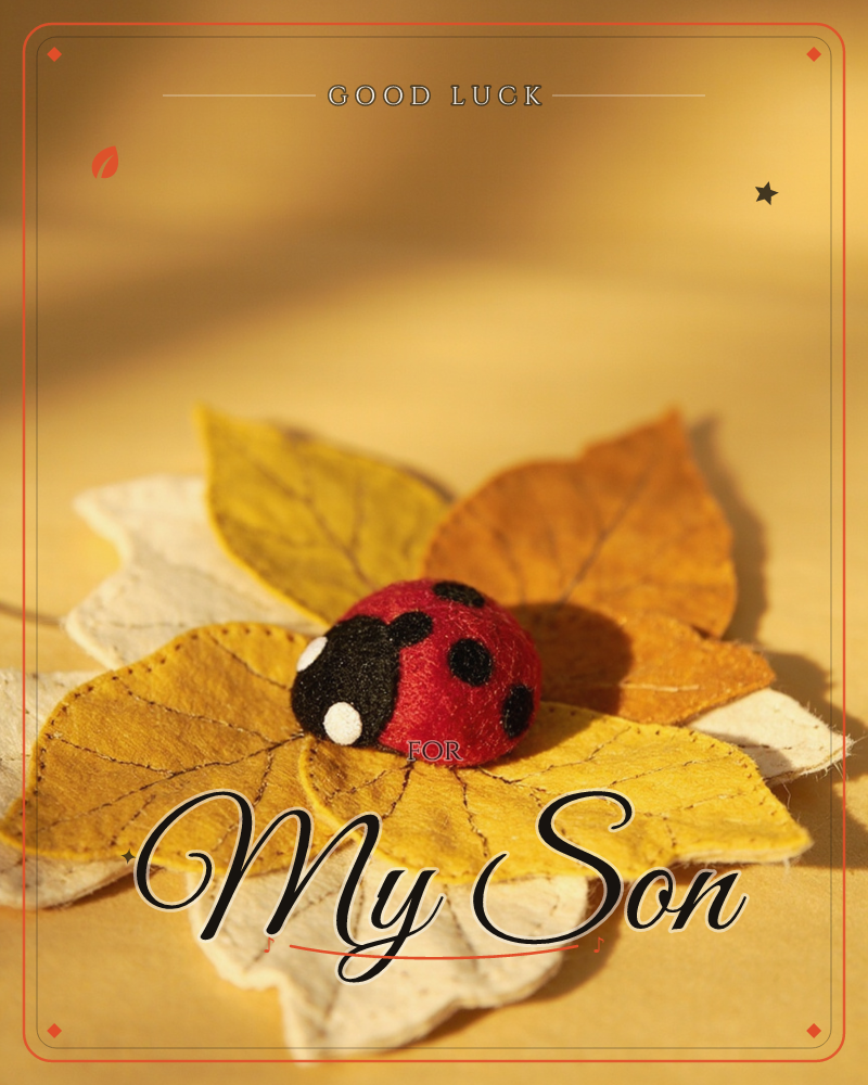 A handmade felt ladybird rests atop a cluster of stitched felt leaves in autumn shades of mustard, amber and cream, all arranged on a warm golden surface, a good luck e-card design