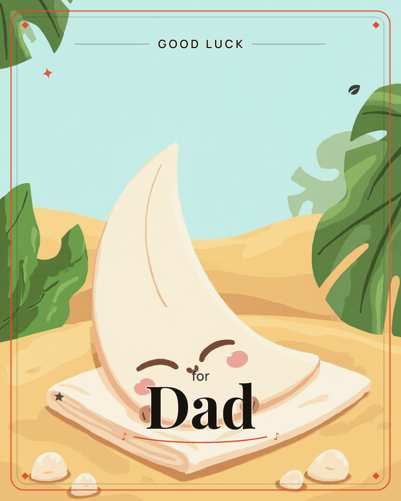 A cheerful crescent-moon-shaped cushion with a sleepy smiling face sits propped on a folded cream blanket, set on a sandy dune, a good luck e-card design