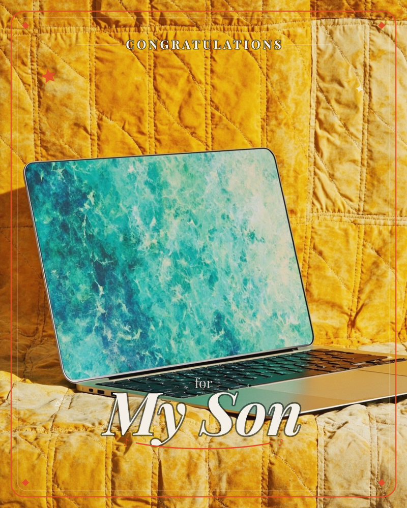 An open laptop sits propped on a quilted mustard-gold blanket, its screen glowing with a swirling turquoise and white marbled pattern like sea foam or…, a graduation e-card design