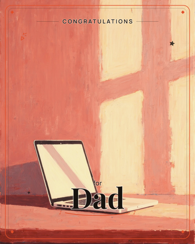A laptop sits alone on a table, its screen glowing pale against a wall washed in deep coral light, a graduation e-card design