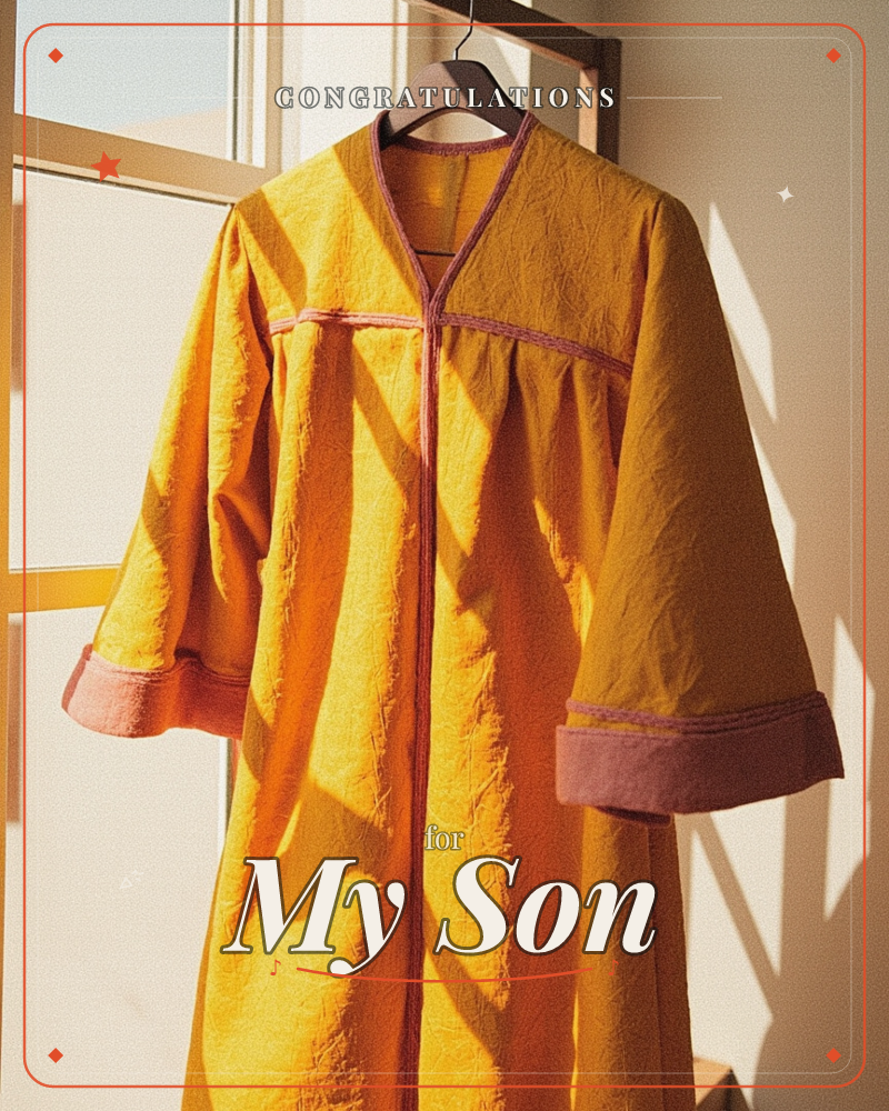 A mustard-yellow robe with rust-pink trim hangs on a wooden hanger against a sunlit window, its wide sleeves and V-neck catching sharp diagonal shadows…, a graduation e-card design