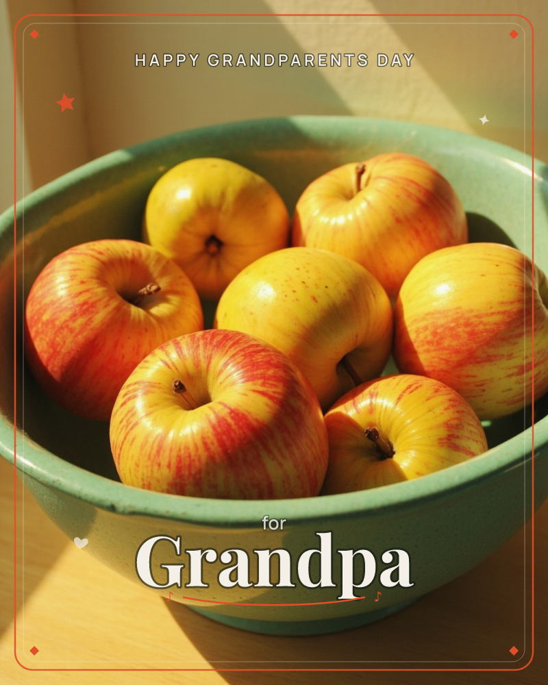 A shallow ceramic bowl in soft sage green holds seven apples, their skins streaked yellow and red, catching low golden sunlight on a wooden tabletop, a grandparents day e-card design