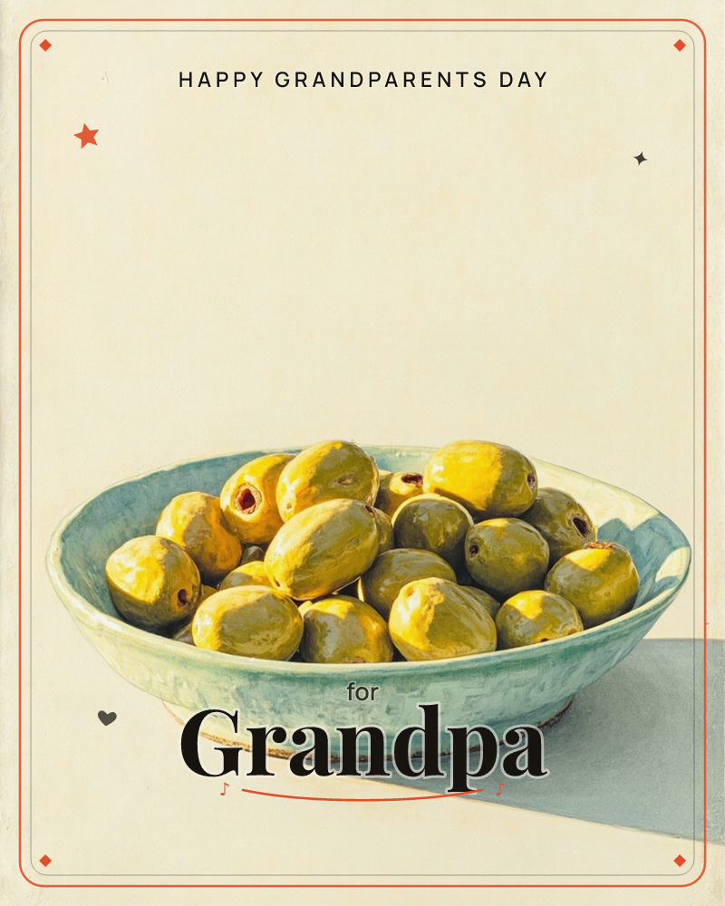 A shallow pale blue-green bowl sits on a bare surface, piled high with plump green olives catching bright, direct light, a grandparents day e-card design