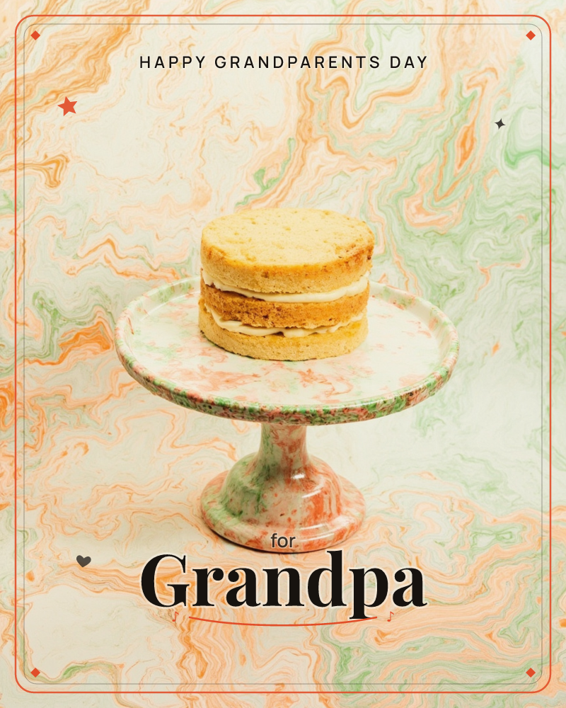 A simple two-layer sponge cake with a pale cream filling sits on a marbled pedestal cake stand, swirled in peach, sage and cream tones that echo the…, a grandparents day e-card design