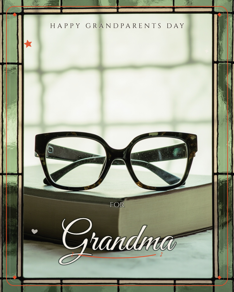 A pair of tortoiseshell reading glasses rests folded atop a thick, closed hardback book, set before a window with a leaded green-glass border, a grandparents day e-card design