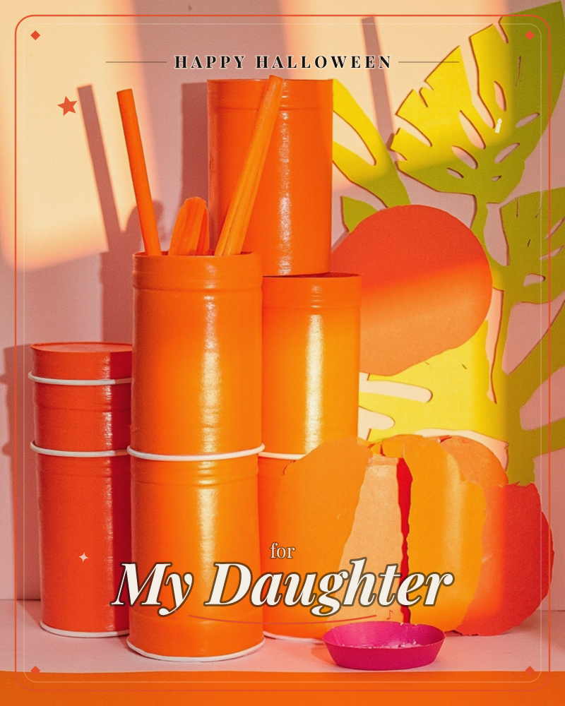 A vivid still life in all-orange tones shows stacked cylindrical tins and tubes, some holding orange drinking straws, arranged beside a giant paper-cut…, a halloween e-card design